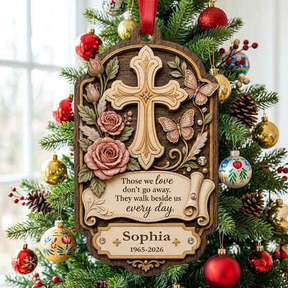 Ornate arch wood ornament with carved cross, roses, butterflies and memorial quote with name and dates.