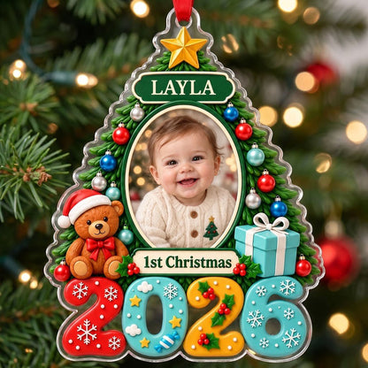 Green Christmas tree acrylic ornament with star topper, baby photo frame, teddy bear, and 2026 numbers.