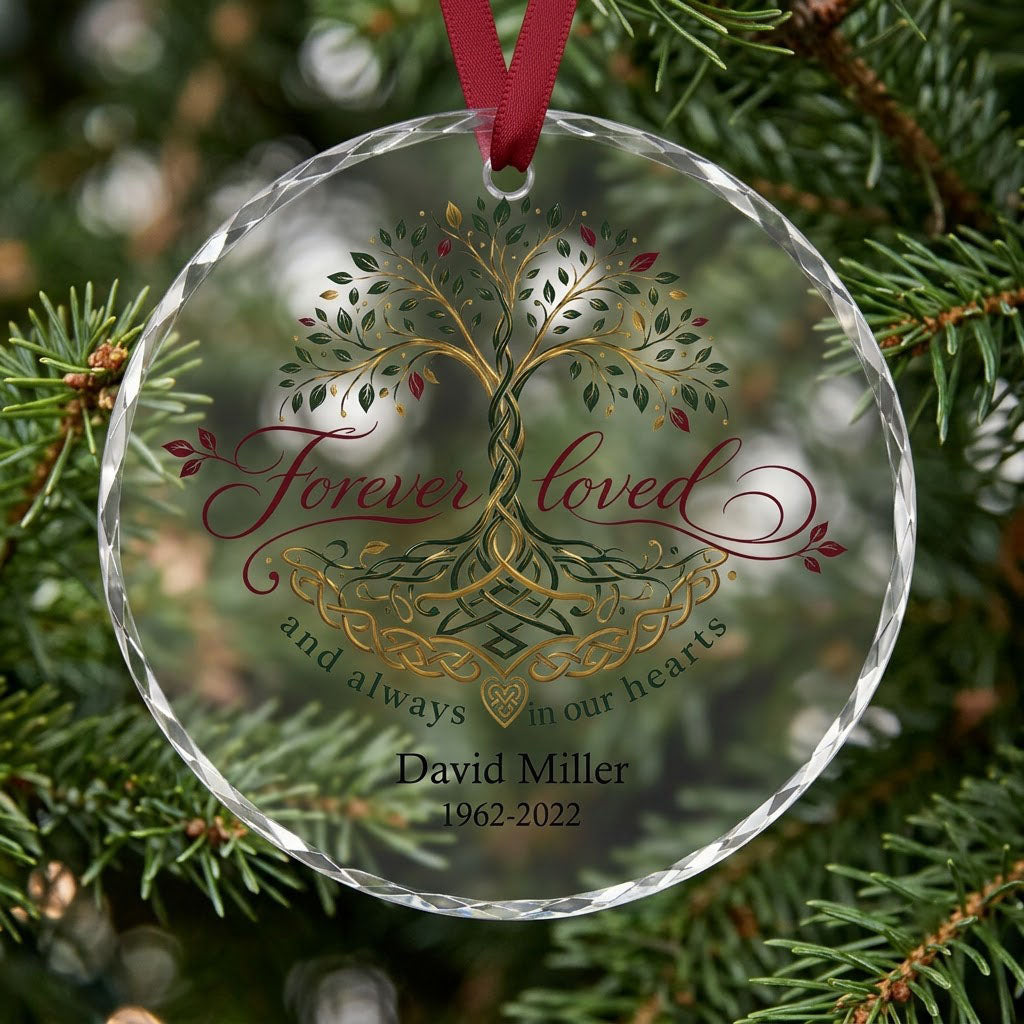 Round glass ornament with Celtic Tree of Life in green, gold and red, reading Forever loved and always in our hearts.