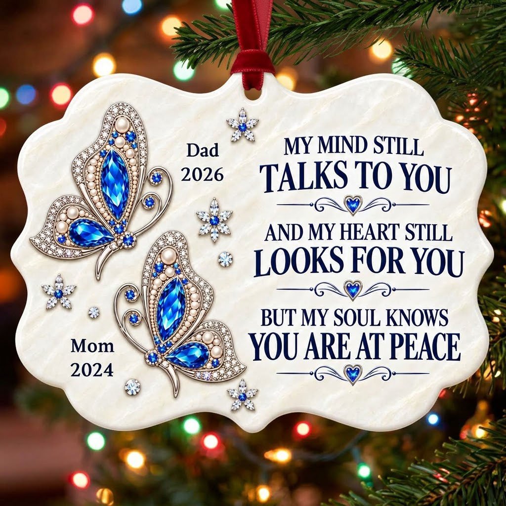Scalloped ceramic ornament with two blue jeweled butterflies, silver starburst flowers and a memorial quote.