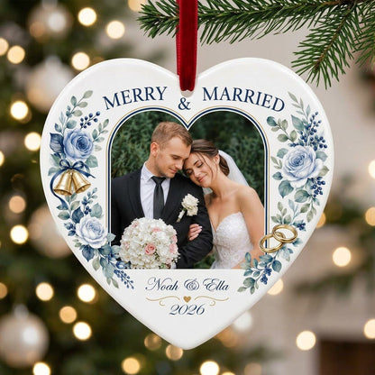 Heart ceramic ornament with “MERRY & MARRIED,” dusty blue florals, wedding bells, rings, and a heart-shaped photo frame.