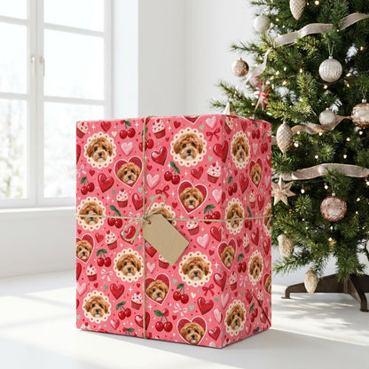 Pink gift wrap with light brown puppy faces, hearts, cherries, cupcakes, bows and sparkles in a repeating pattern