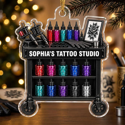 Acrylic ornament shaped like a tattoo cart with machines, colorful inks, and 'SOPHIA'S TATTOO STUDIO' text.