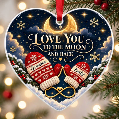 Heart ceramic ornament with golden crescent moon, red mittens, snowflakes and pine, personalized with two names.