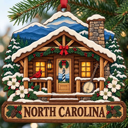 Log cabin ornament with NORTH CAROLINA banner, red cardinal, banjo, dogwood flowers, pine trees, and blue mountains.