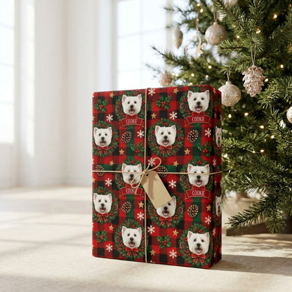 Red and green plaid wrapping paper with Westie in wreaths, snowflakes, stars, holly, and a name on red banners.
