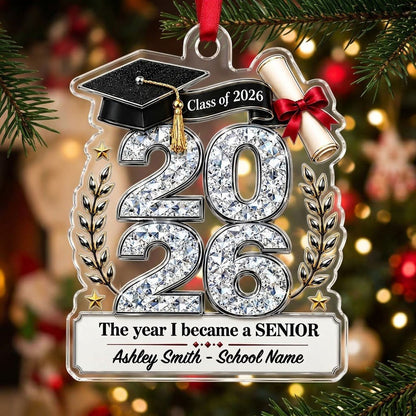 Custom-cut clear acrylic ornament shaped like a graduation cap with Class of 2026, diploma, laurels, and name plaque.