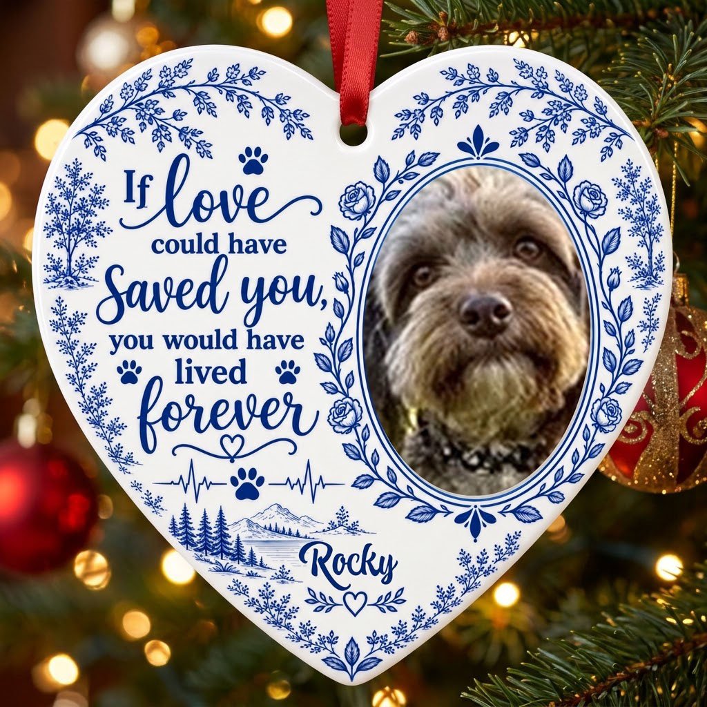 White heart ceramic ornament with blue dog photo frame wreath, memorial quote, paw heartbeat, and a mountain lake scene.