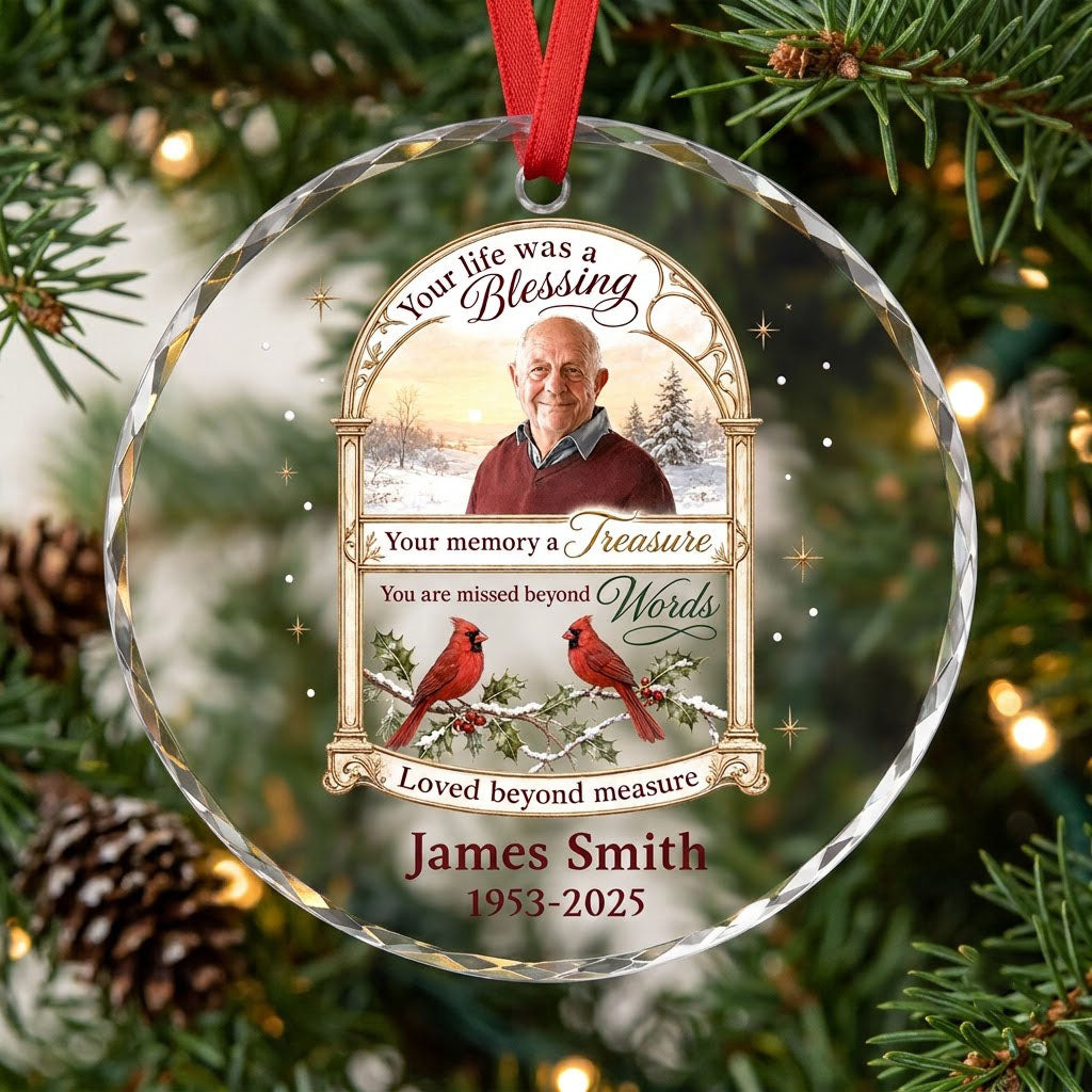 Round glass ornament with golden arched photo frame, two red cardinals on snowy pine and a memorial quote.