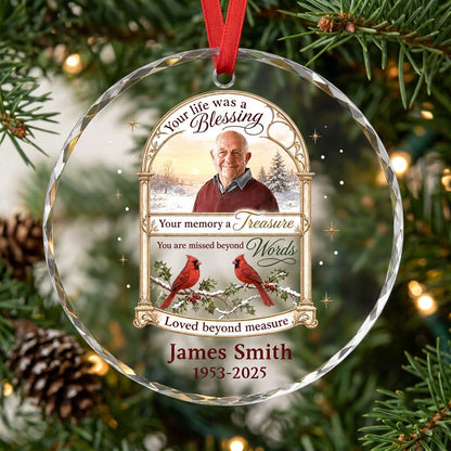 Round glass ornament with golden arched photo frame, two red cardinals on snowy pine and a memorial quote.