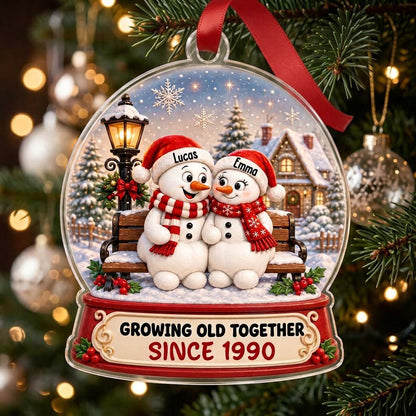 Acrylic snowglobe ornament with two snowmen on a bench, Santa hats, and Growing Old Together text.