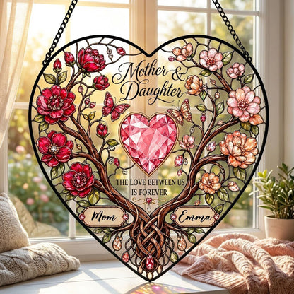Heart-shaped stained-glass style suncatcher with intertwined trees, red and pink flowers, butterflies, and a pink gem he