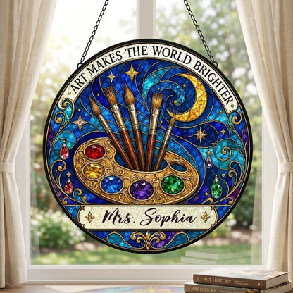 Round stained-glass suncatcher with golden palette, five brushes, moon, and 'Art Makes the World Brighter'.