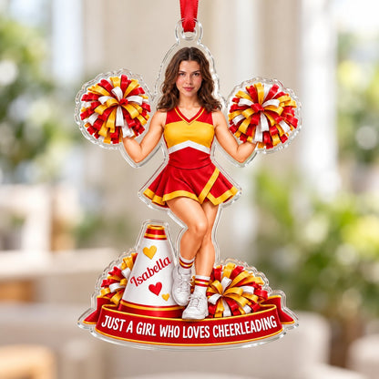 Custom-cut acrylic ornament of a cheerleader in red and yellow with pom-poms, a white megaphone, and a red name banner