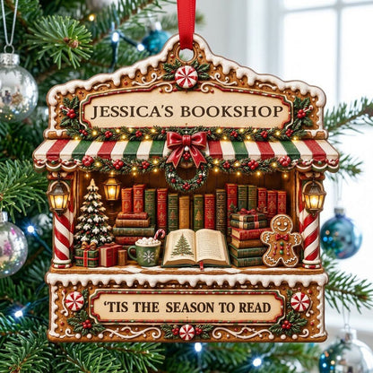 Gingerbread bookstore facade ornament with striped awning, wreath, books, lanterns, and 'TIS THE SEASON TO READ' text.
