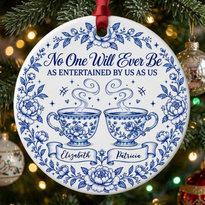 Round white ceramic ornament with blue floral border and two teacups, personalized with two names
