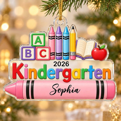 Clear acrylic ornament with ABC blocks, crayons, apple, open book and 'Kindergarten 2026' with a pink name banner