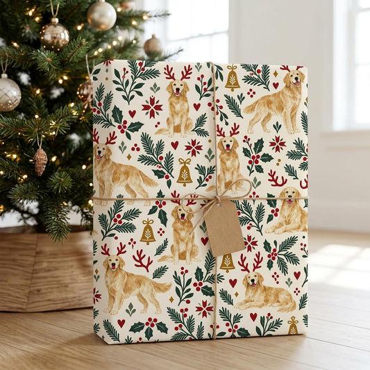 Cream wrapping paper with golden retrievers in red antler headbands, pine sprigs, red berries and gold bells.