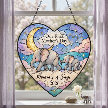 Heart stained-glass suncatcher with mom and baby elephants, crescent moon, pastel clouds, and gold stars.
