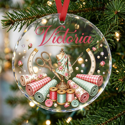 Round faceted glass ornament with a vintage dress form, sewing notions, and personalized name Victoria in pink and gold 