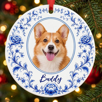 Round ceramic ornament with blue Delft floral border framing a circular photo of a dog and a personalized name.