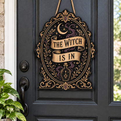 Gothic plaque sign reading "THE WITCH IS IN" with crescent moon, stars, purple smoke, potion bottle and ornate filigree 