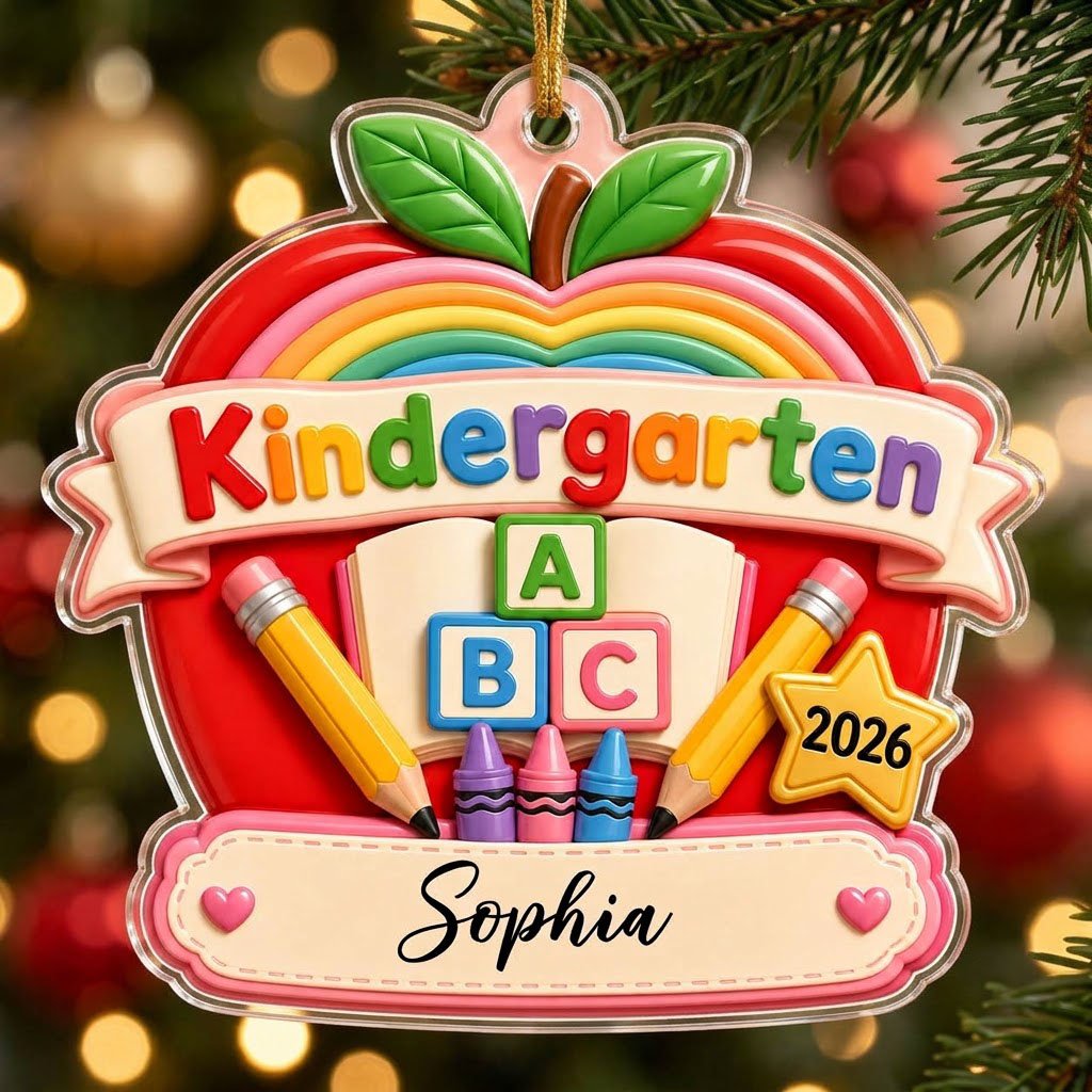 Red apple acrylic ornament with 'Kindergarten 2026', rainbow, ABC blocks, crayons, pencils, star badge, and a name banne
