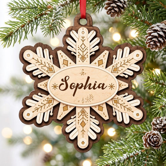 Layered wood snowflake ornament with geometric engravings and a central oval name plate for a custom name.