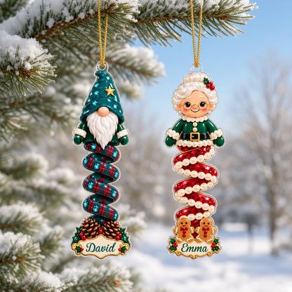 Clear acrylic ornament with a cartoon elf or Mrs. Claus, spiral ribbon body, holly, and a white name scroll.