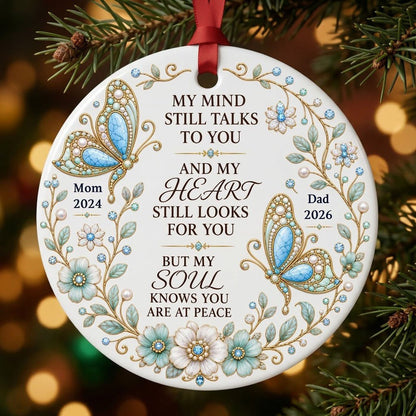 White round ornament with jeweled butterflies, floral wreath, and memorial quote with personalized name and year.