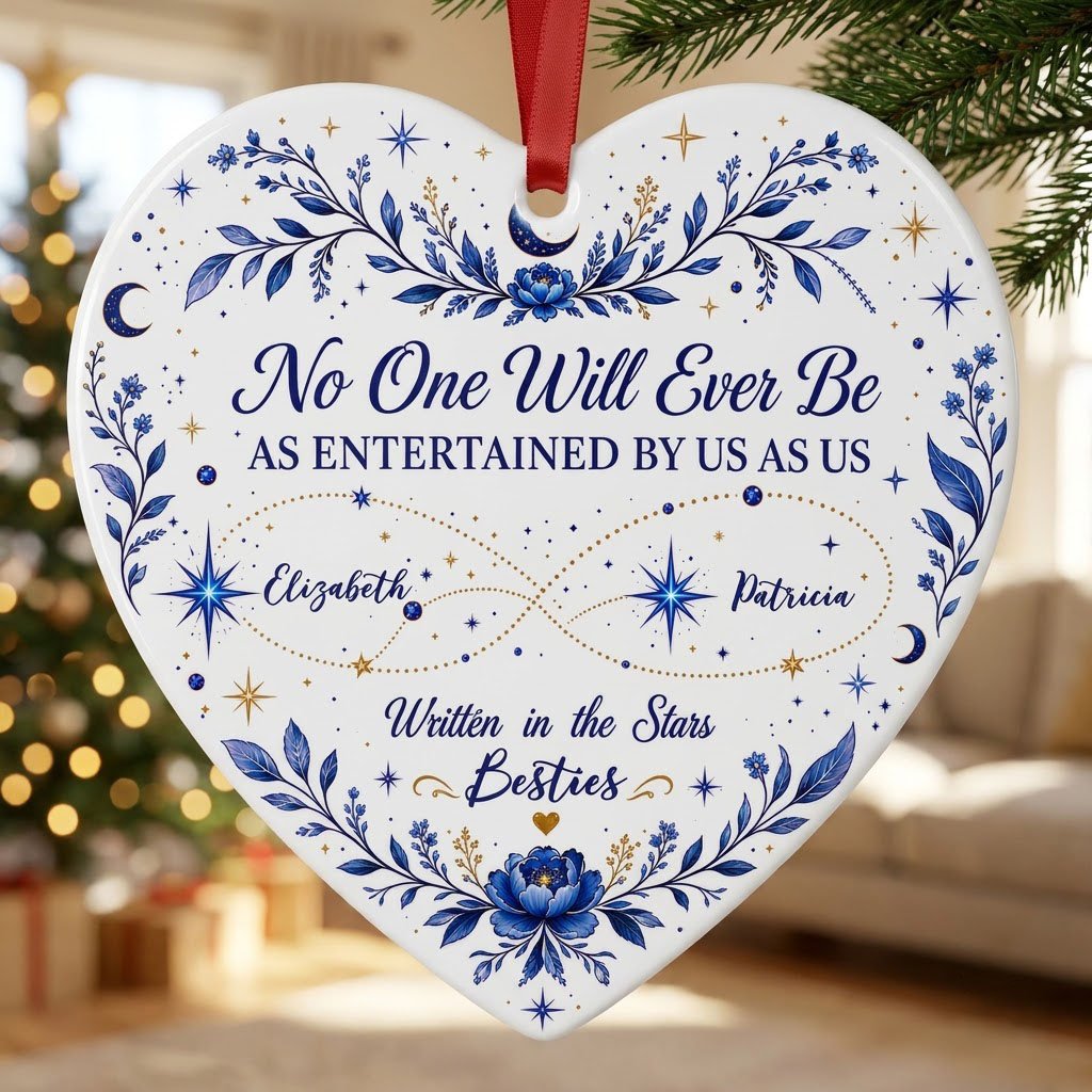 White heart ceramic ornament with blue florals, moons, stars, and “Written in the Stars Besties” with two names.