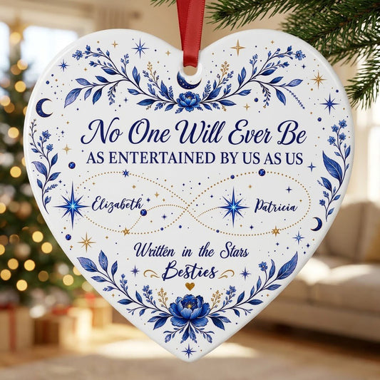 White heart ceramic ornament with blue florals, moons, stars, and “Written in the Stars Besties” with two names.