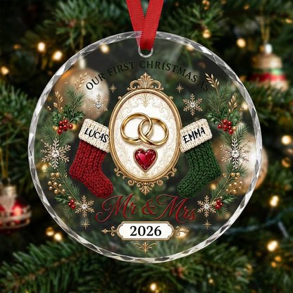 Round glass ornament with gold rings, red heart gem, red and green stockings, pine branches and Mr & Mrs text.