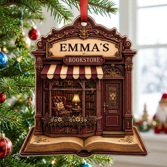 Custom-cut wood ornament of a vintage bookstore with 'BOOKSTORE' and a name above, over an open book base.