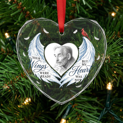 Heart-shaped glass ornament with blue angel wings, red cardinal, and a memorial quote with name and years.