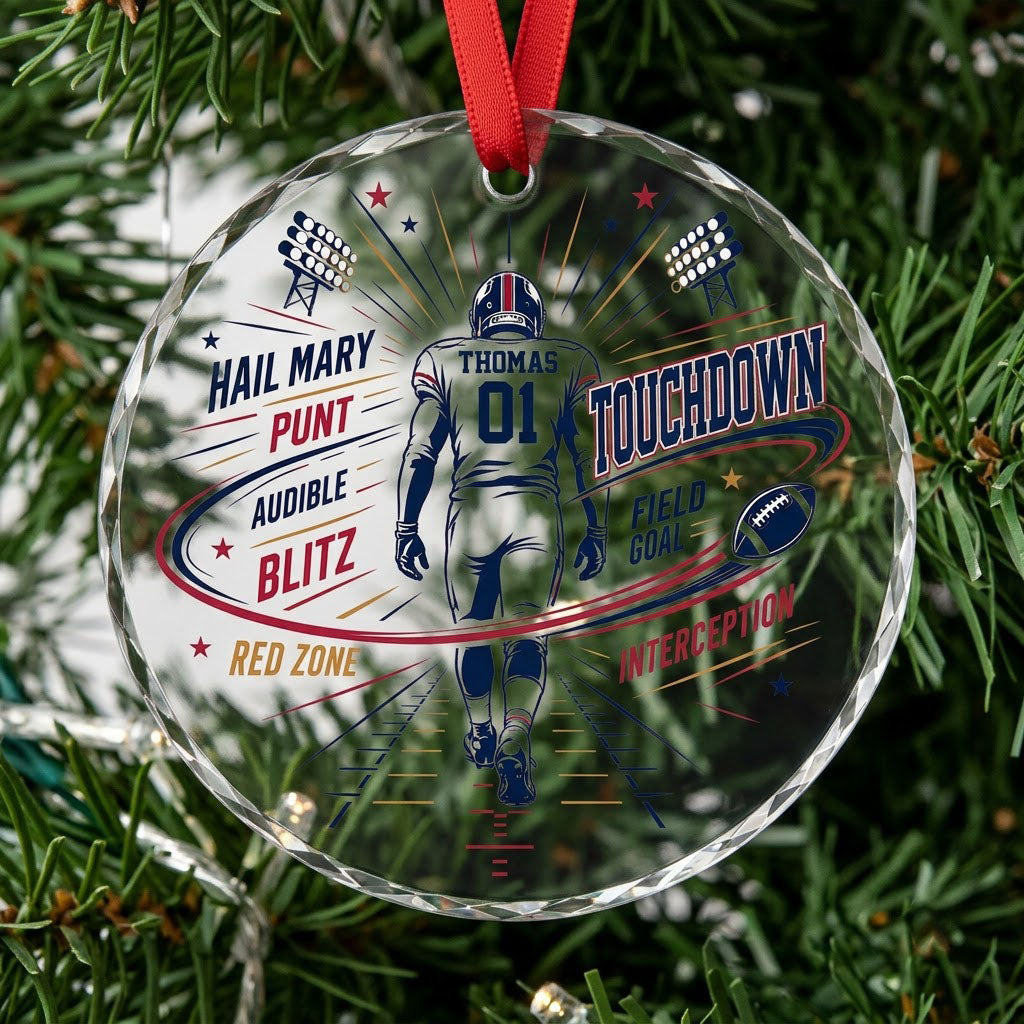 Round faceted glass ornament with football player back view, stadium lights, navy swoosh, and name and number.