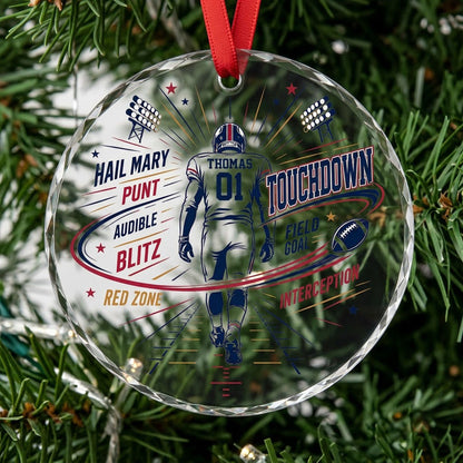 Round faceted glass ornament with football player back view, stadium lights, navy swoosh, and name and number.