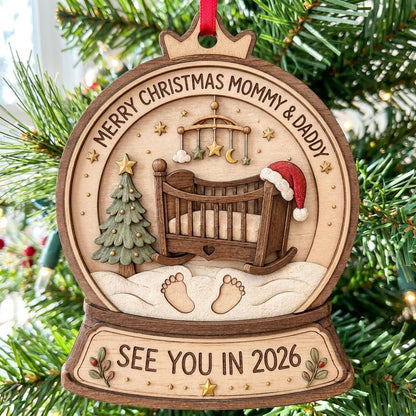 Snow globe wood ornament with crib, Santa hat, mobile, tree, footprints, and Merry Christmas Mommy & Daddy text.