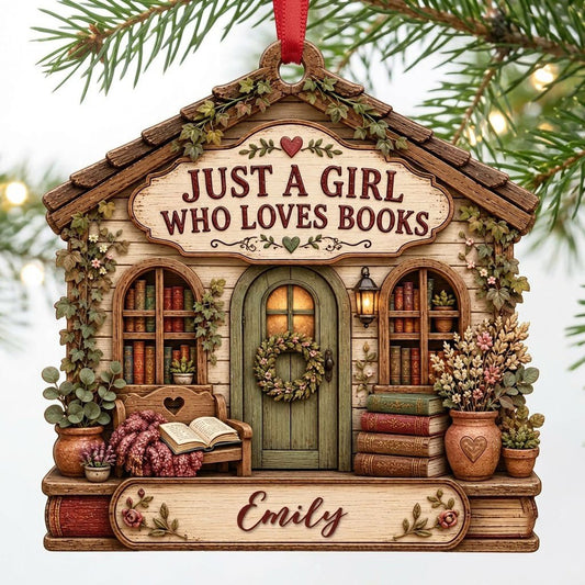 House-shaped wood ornament with 'JUST A GIRL WHO LOVES BOOKS', bookshelves, green door with wreath, and the name Emily.