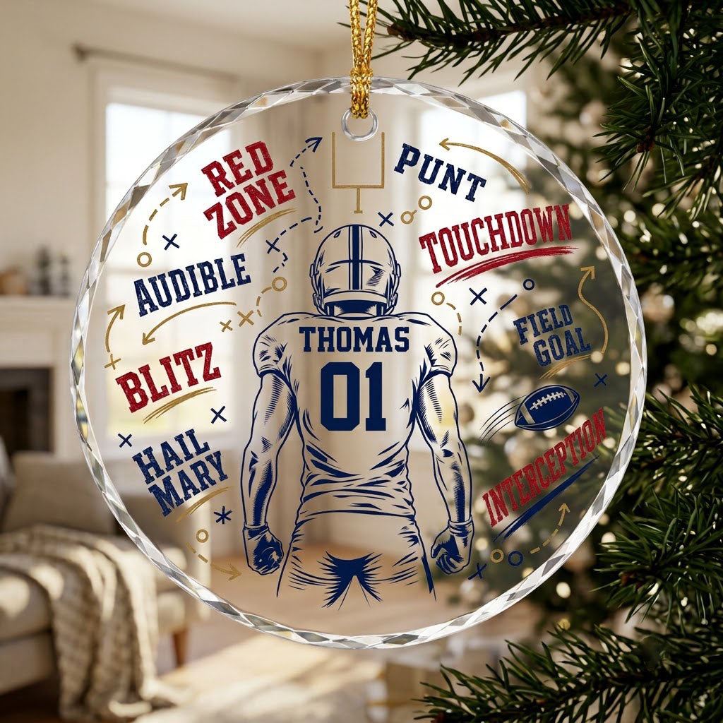 Round faceted glass ornament with football player back view, goalpost, football, and play diagrams in navy, dark red, an
