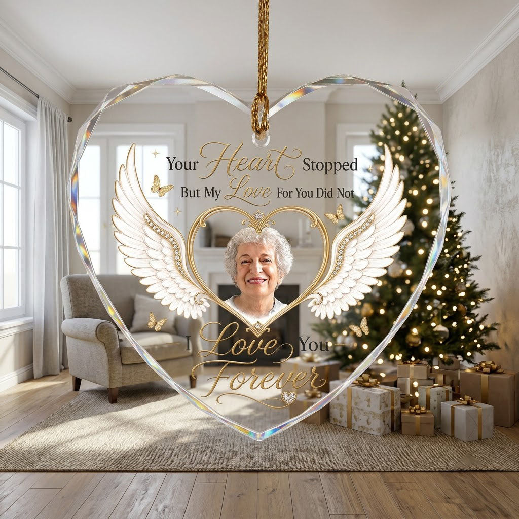Heart-shaped glass ornament with white angel wings, gold heart photo frame, golden butterflies and sparkles.