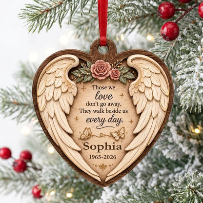 Heart-shaped wood ornament with angel wings, pink roses, butterflies, and a memorial quote with name and dates.