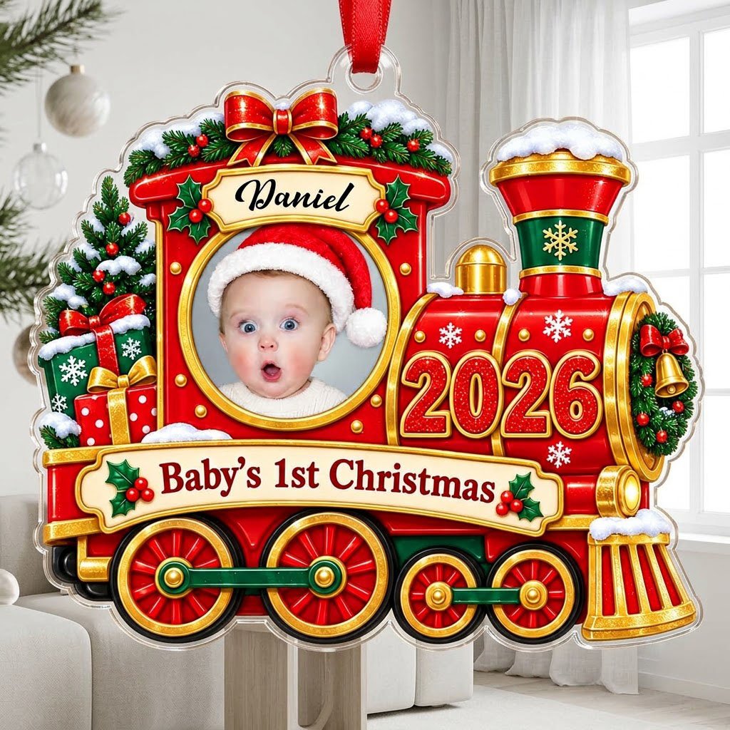 Red and gold train ornament with circular baby photo, bow, holly, wreath and 'Baby's 1st Christmas' on a scroll banner.