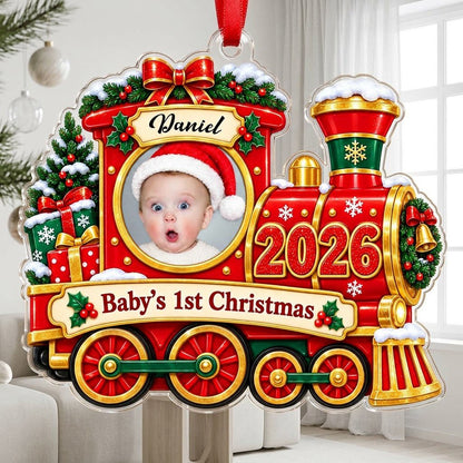 Red and gold train ornament with circular baby photo, bow, holly, wreath and 'Baby's 1st Christmas' on a scroll banner.