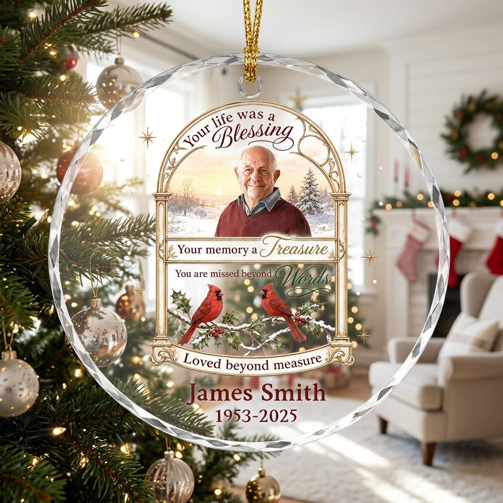 Round glass ornament with golden arched photo frame, two red cardinals on snowy pine and a memorial quote.