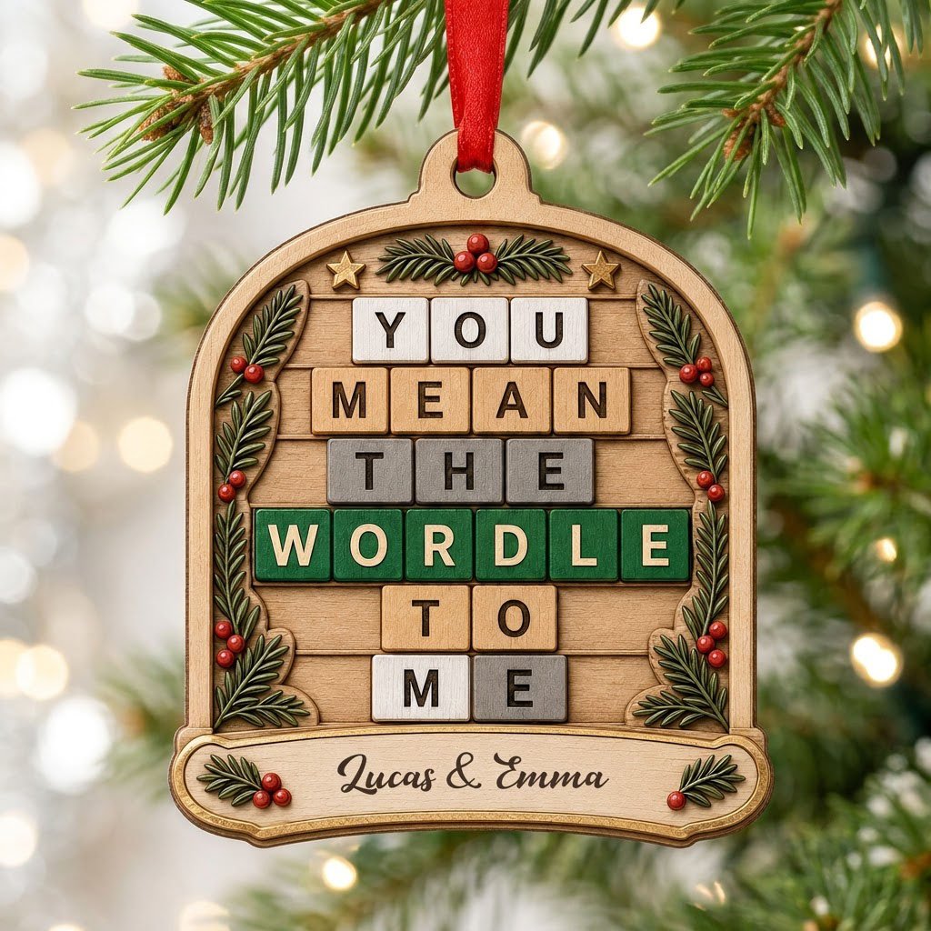 Arch wood ornament with “You Mean The Wordle To Me” letter tiles, evergreen sprigs with red berries, gold stars, and cou