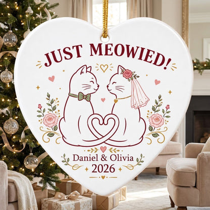 Two white cats with bow tie and bridal veil under JUST MEOWIED with roses and stars on a heart ceramic ornament.