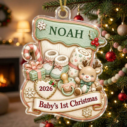 Stocking-shaped acrylic ornament with baby booties, reindeer toy and Baby's 1st Christmas on a cream banner.