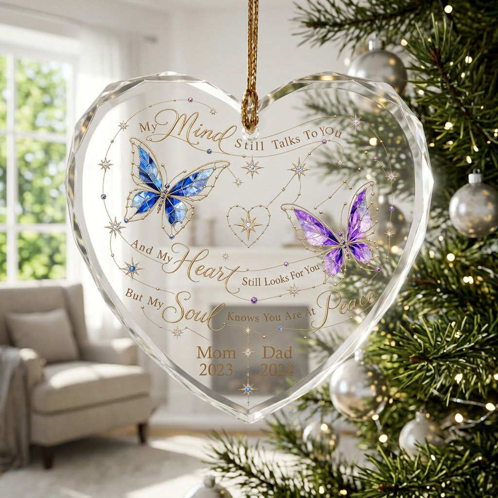 Heart-shaped glass ornament with blue and purple stained-glass butterflies, gold swirls, and memorial text.