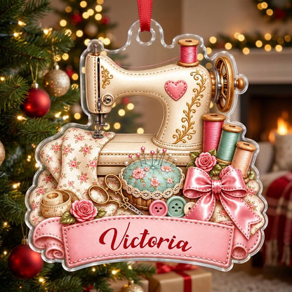 Custom-cut acrylic ornament with vintage cream sewing machine, pink banner, roses, thread spools and scissors.